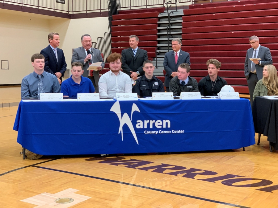 table with several people surrounding it